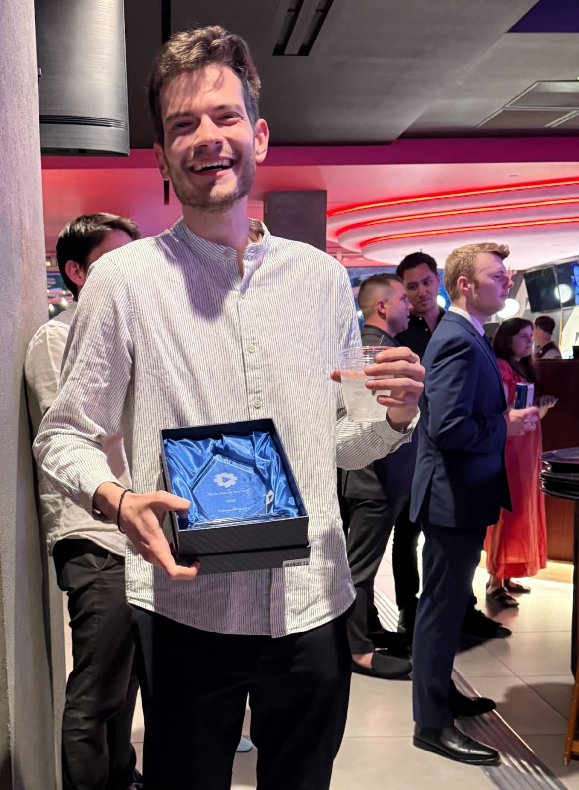 Nikolas Bakalis holding a Tech Star of the Year award
